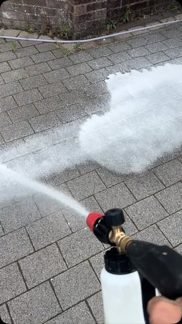 Pressure washing an exterior paved surface