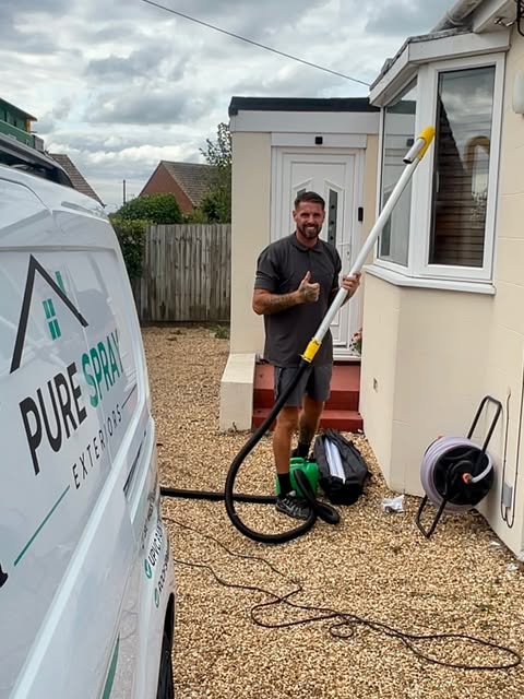 Jason with gutter cleaning equipment outside a customer's property